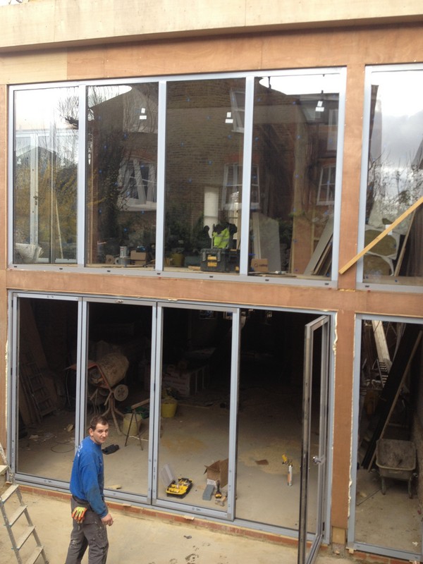 Aluminium bi-fold doors with two-storey glazing in West Kensington
