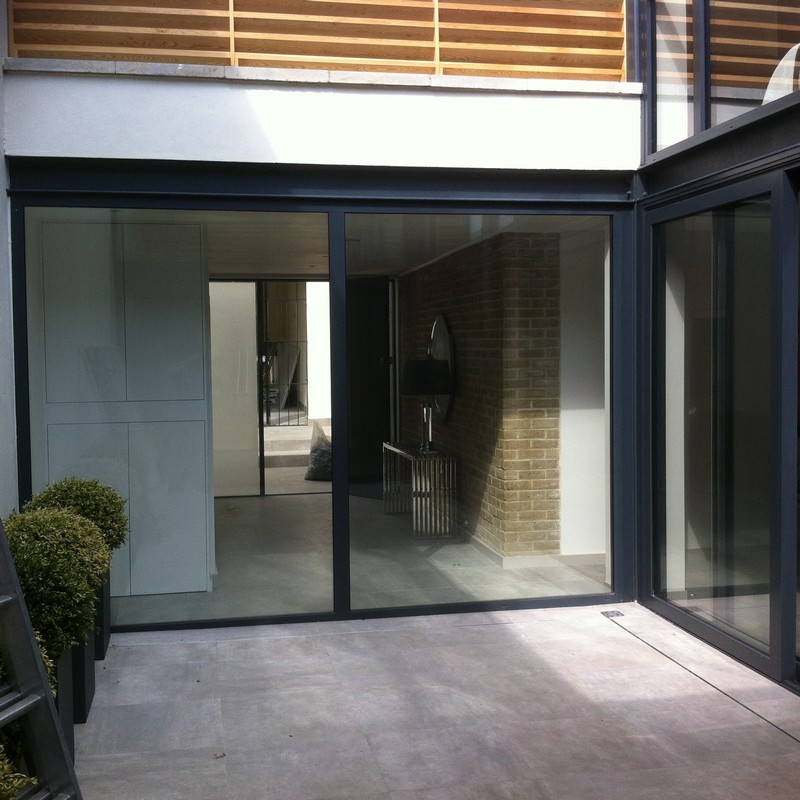 Floor-to-ceiling sliding doors opening to courtyard in West Kensington