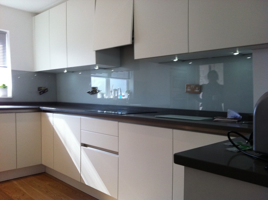 Grey glass kitchen splashback with LED lighting in West Kensington